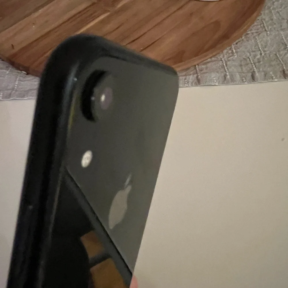 Apple Black XR - 128 GB, unlocked phone with two cases.